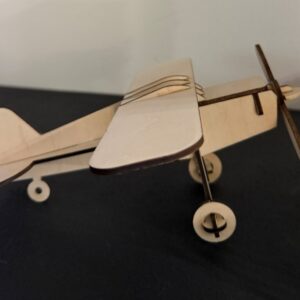 Natural wood high-wing model airplane with propeller and landing gear