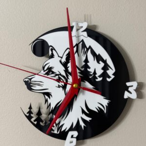 Black and white acrylic wolf wall clock with red hands and forest backdrop