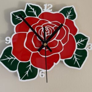 Red rose acrylic wall clock with green leaves, white outline and black hands
